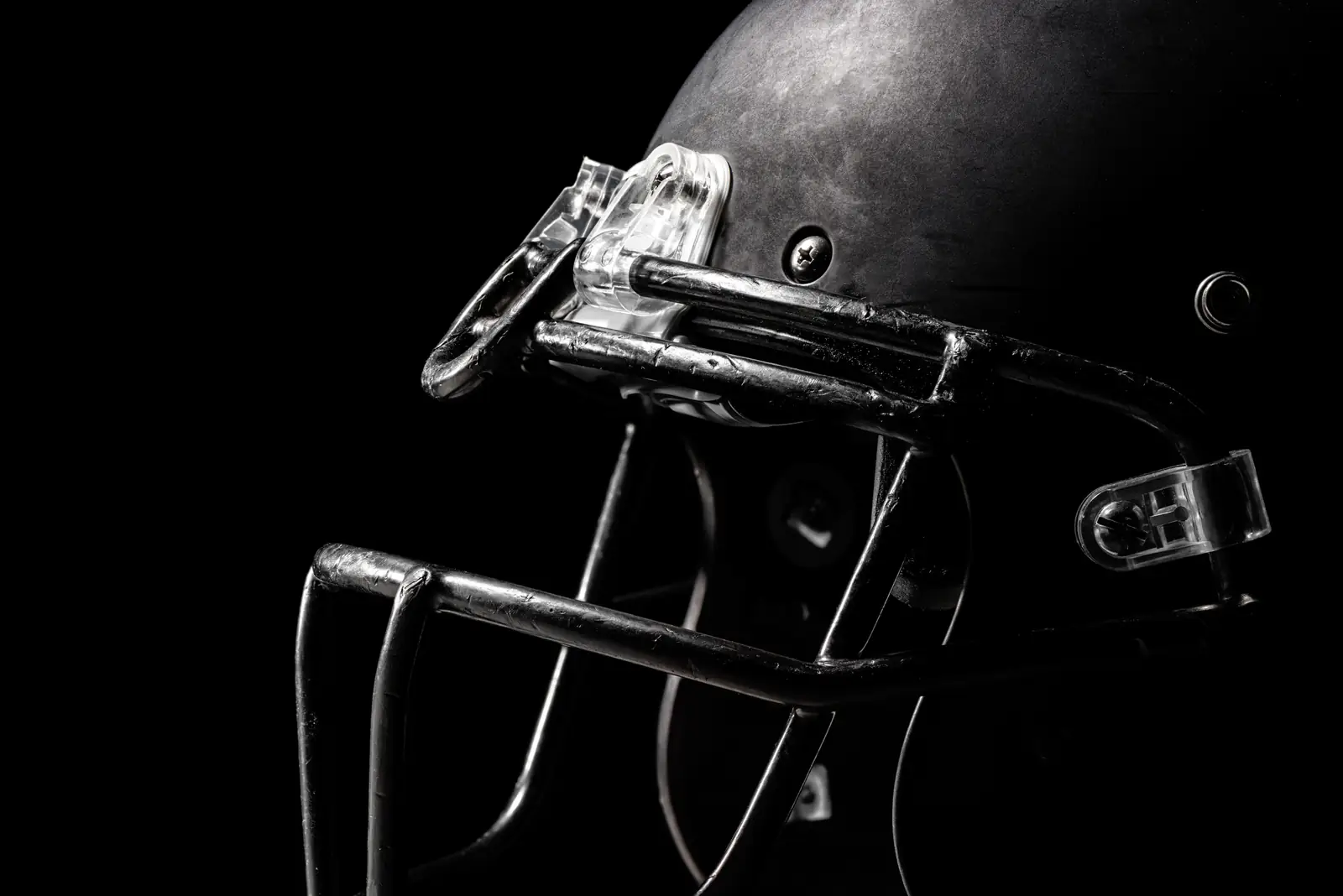 American football helmet in dramatic low light